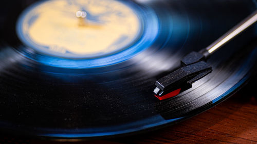 Record player needle macro view on wood table