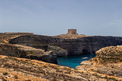 Scenic view of fort by sea against sky