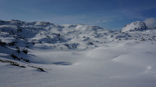 Scenic view of snowcapped mountains against sky