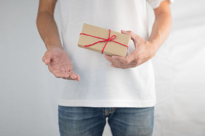 Midsection of woman holding paper in box