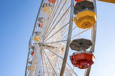Low angle view of of colorful ferris wheel at santa monica pier