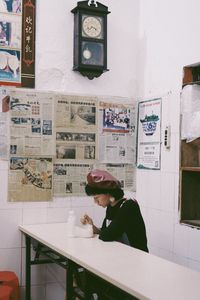 Side view of man sitting on table at restaurant