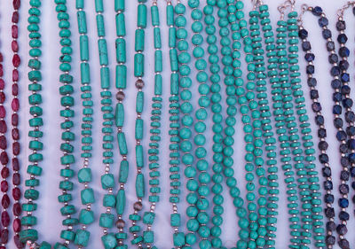 High angle view of necklaces arranged on table for sale in store