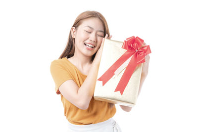 Portrait of a smiling young woman against white background
