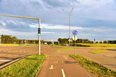 Road sign - the end of cycle path in city at pedestrian zone. green traffic light signal