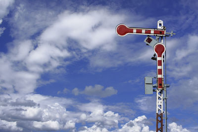 Low angle view of communications tower against sky