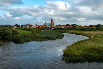 River amidst buildings against sky