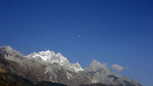 Scenic view of mountains against blue sky