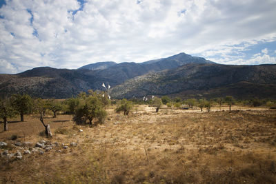 Scenic view of mountains against cloudy sky