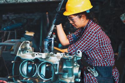 Smart young woman working in factory, engineering woman working at factory, working woman concept.