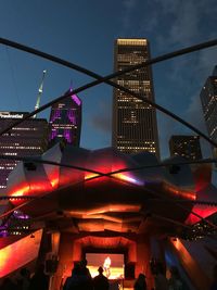 Low angle view of illuminated buildings at night