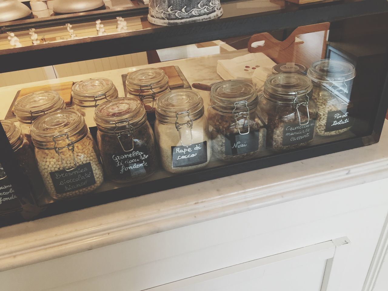 indoors, still life, table, variation, glass - material, shelf, food and drink, choice, high angle view, no people, arrangement, store, large group of objects, retail, art and craft, transparent, text, jar, close-up, art