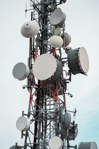 Low angle view of communications tower against sky