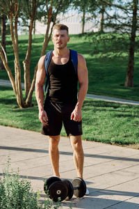 Portrait of young man exercising in gym