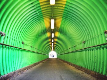 Road in green metallic tunnel