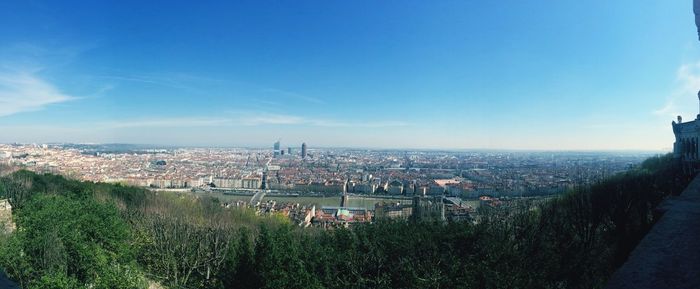 View of cityscape against blue sky