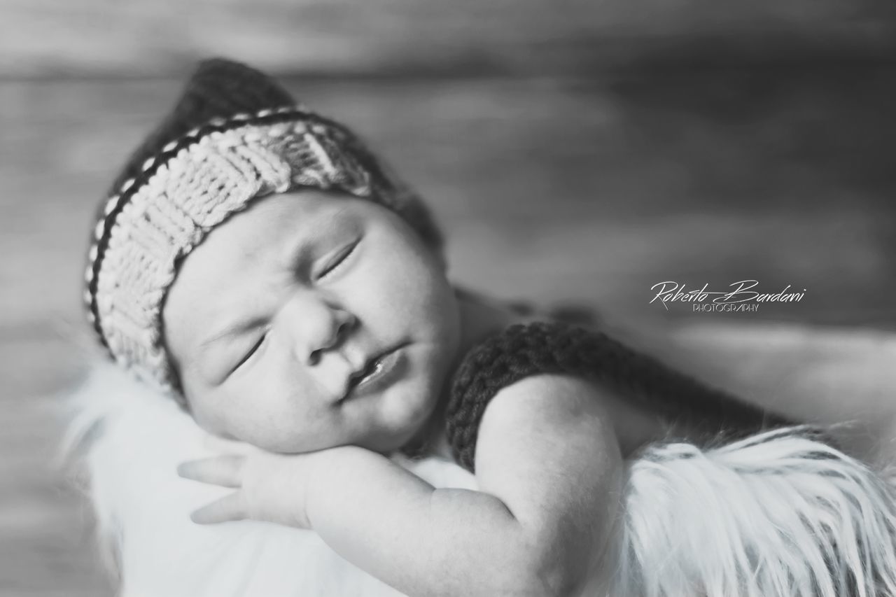 child, childhood, headshot, eyes closed, one person, cute, real people, clothing, relaxation, portrait, sleeping, hat, innocence, babyhood, close-up, baby, leisure activity, resting, warm clothing, softness