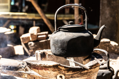 Close-up of tea kettle on fire pit