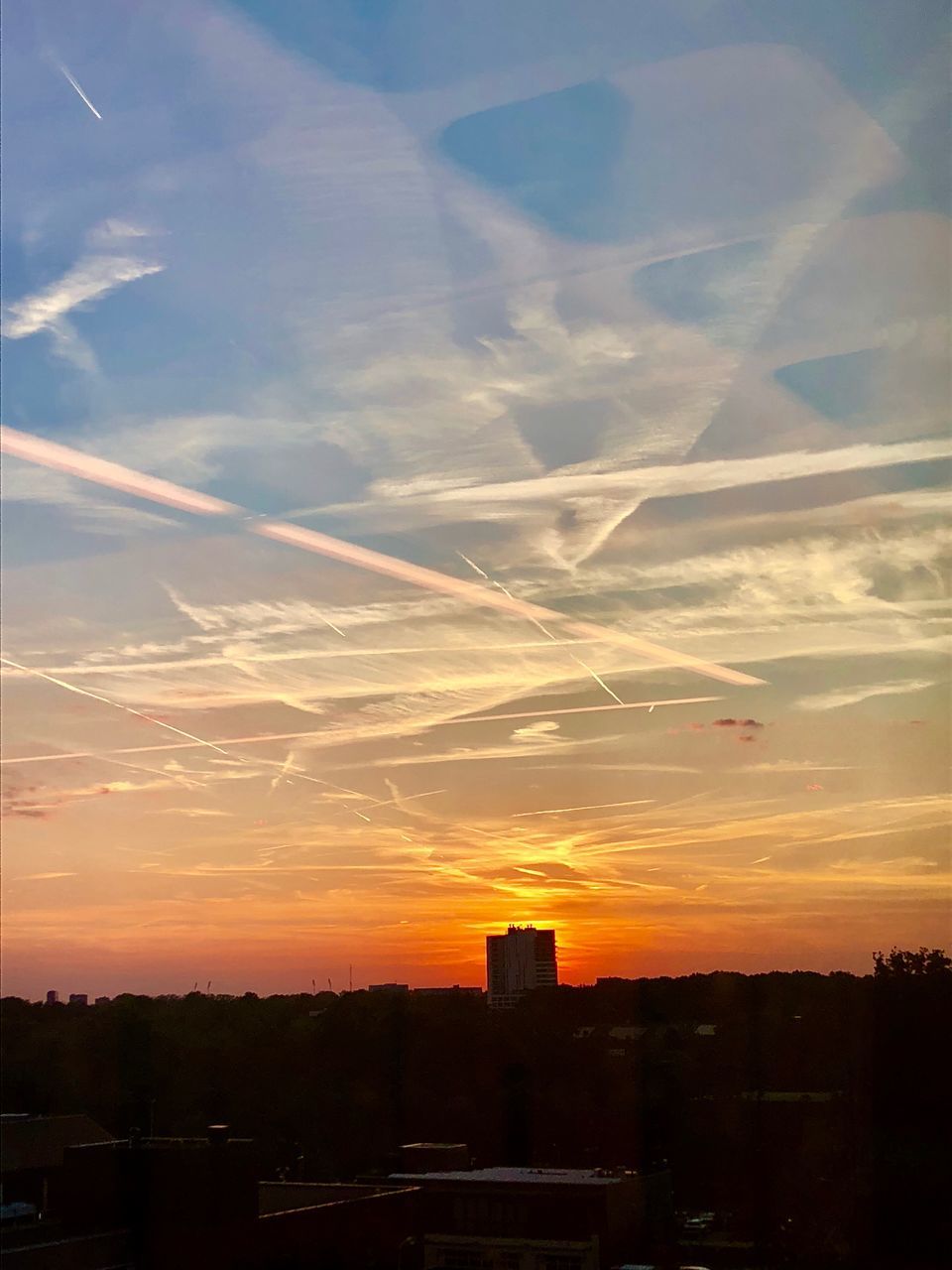 SILHOUETTE BUILDINGS AGAINST ORANGE SKY