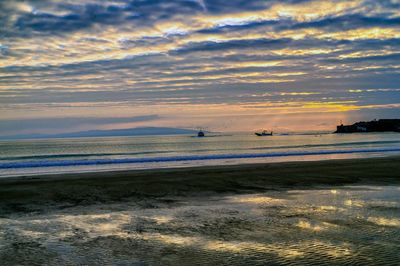 Scenic view of sea against cloudy sky