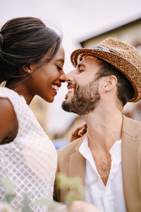 Midsection of man and woman with hat