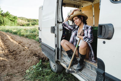 Full length of woman sitting in car