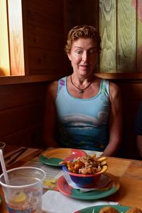 Surprise woman looking at food on table in restaurant