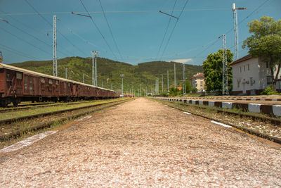 Railroad tracks amidst buildings against sky