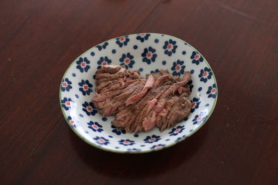 High angle view of sliced grilled beef in plate on table