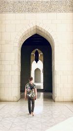 Full length of man standing at entrance of historic building