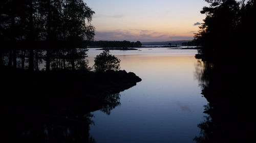 Scenic view of lake against sky at sunset
