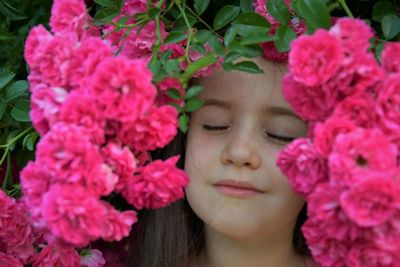 Close-up of girl amidst pink flowers