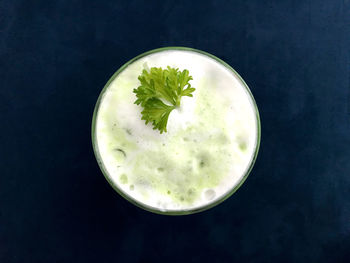 Directly above shot of drink on table against black background