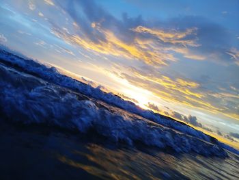 Close-up of sea against sky during sunset