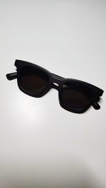 Close-up of sunglasses against white background