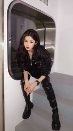 Portrait of young woman sitting in train