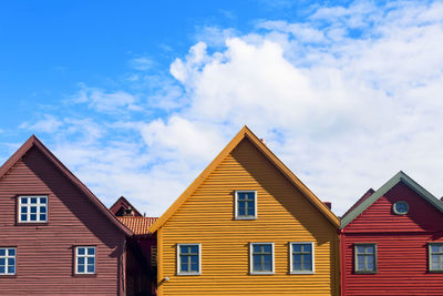 View of multi colored houses against sky