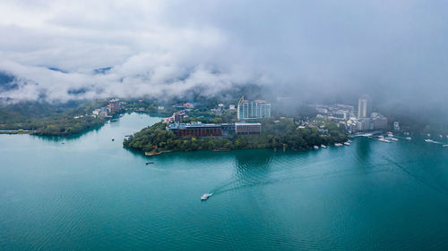 Aerial view of sea against cloudy sky