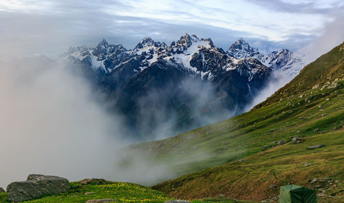 View of waterfall against cloudy sky