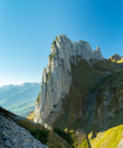 Scenic view of mountains against clear blue sky