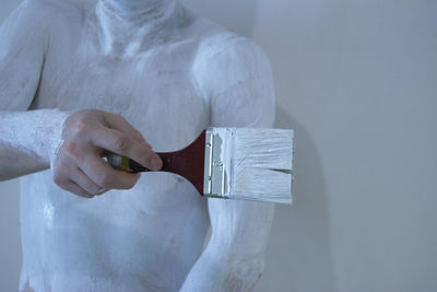 Midsection of man painting body