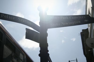 Low angle view of road sign against sky