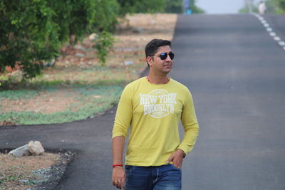 Man wearing sunglasses standing on road