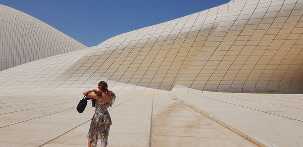 Full length of woman standing against sky