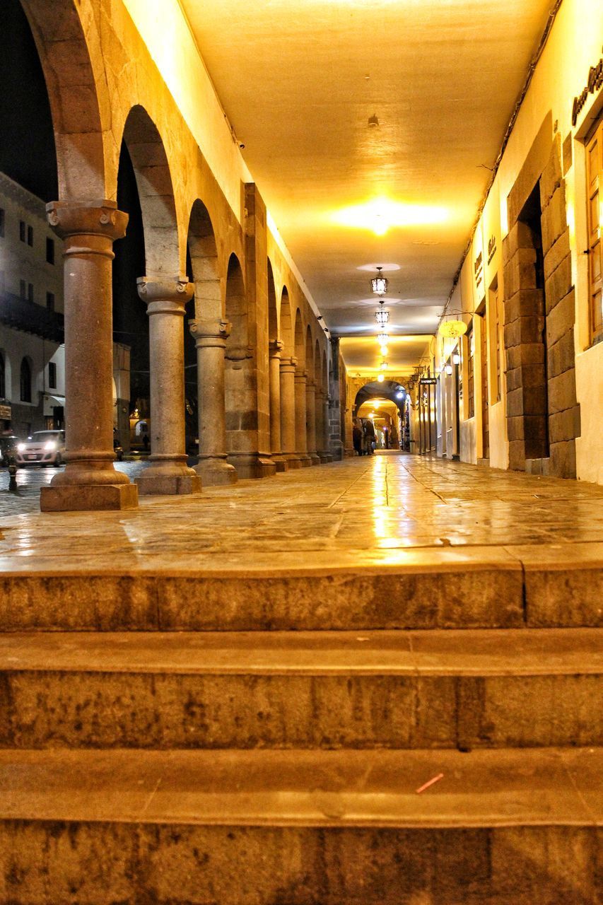 ILLUMINATED CORRIDOR OF HISTORIC BUILDING IN CITY