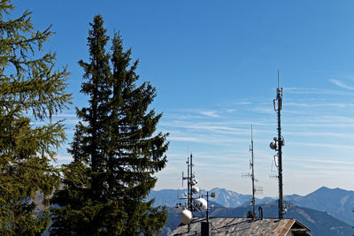 Trees and tower against sky during winter