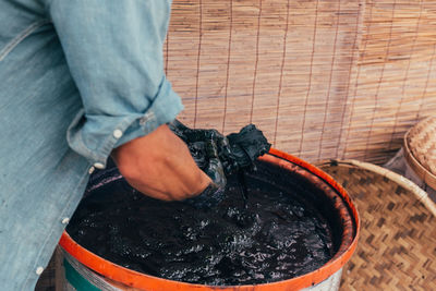 Midsection of man working in dye