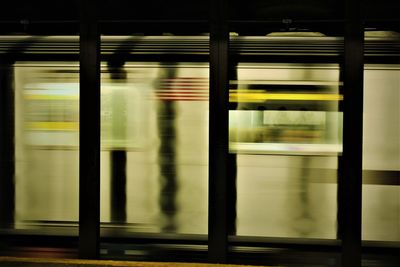Blurred motion of train at railroad station