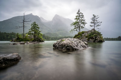 Scenic view of rocks in lake against sky