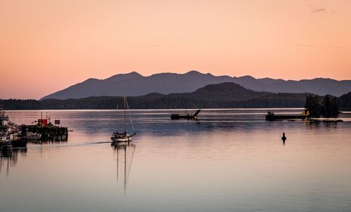 Scenic view of lake against clear sky during sunset